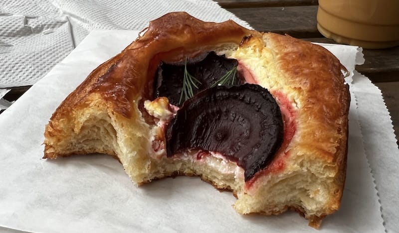 A goat cheese and beet pastry minus a few bites.